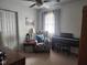 Bedroom features a ceiling fan, neutral carpet, accent chair, and upright piano at 7870 E County Road 150 S, Avon, IN 46123
