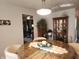 Sunlit dining area with modern light fixture, glass-top table, and stylish decor at 7870 E County Road 150 S, Avon, IN 46123