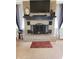 Close-up of a brick fireplace with black mantel, decorative accessories, and neutral colored walls at 7870 E County Road 150 S, Avon, IN 46123