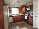 Well-lit kitchen featuring stainless steel appliances, and dark wood cabinets at 7870 E County Road 150 S, Avon, IN 46123