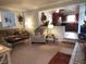 Open concept living room with a partial view of kitchen featuring dark wood cabinets and stainless steel appliances at 7870 E County Road 150 S, Avon, IN 46123