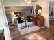 Living room with a ceiling fan, dark wood floors, bar seating, and updated furniture at 7870 E County Road 150 S, Avon, IN 46123
