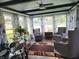 Cozy sun room featuring a ceiling fan, many windows, and comfortable seating at 7870 E County Road 150 S, Avon, IN 46123