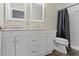 Bathroom with a modern vanity, dual mirrors, and a shower with a gray shower curtain at 802 N Tuxedo St, Indianapolis, IN 46201