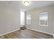 This bedroom features hardwood floors, neutral paint, two windows, and stairs leading to a lower level at 802 N Tuxedo St, Indianapolis, IN 46201