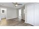 This bedroom features hardwood floors, neutral paint, a ceiling fan, a large closet, and an en-suite bathroom at 802 N Tuxedo St, Indianapolis, IN 46201