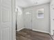 Bright entryway featuring wood plank flooring, a sidelight window, and a white exterior door at 802 N Tuxedo St, Indianapolis, IN 46201