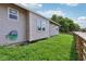 View of the back of the house, showing the yard, siding, windows and a portion of the wood fence at 802 N Tuxedo St, Indianapolis, IN 46201