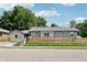 Charming single-story home with a well-maintained yard and natural wood fence under a bright blue sky at 802 N Tuxedo St, Indianapolis, IN 46201