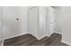 Hallway featuring wood plank flooring and two white paneled doors at 802 N Tuxedo St, Indianapolis, IN 46201