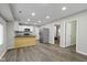 Kitchen featuring wood floors, stainless steel appliances, granite countertops and access to living spaces at 802 N Tuxedo St, Indianapolis, IN 46201
