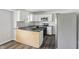 Well-lit kitchen with stainless steel appliances, granite countertops, white cabinets and plank flooring at 802 N Tuxedo St, Indianapolis, IN 46201