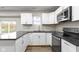 Kitchen featuring stainless steel appliances, granite countertops and a crisp white cabinetry for a sleek design at 802 N Tuxedo St, Indianapolis, IN 46201