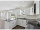 Modern kitchen features granite countertops, white cabinets, stainless steel appliances and plank flooring at 802 N Tuxedo St, Indianapolis, IN 46201