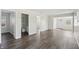 View of the living room showing bathroom entrance, front door, and laminate floors at 802 N Tuxedo St, Indianapolis, IN 46201