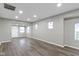 Neutral living room with wood floors, recessed lighting and multiple windows that provide a bright, open space at 802 N Tuxedo St, Indianapolis, IN 46201