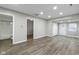 Neutral living room featuring wood floors, access to a bathroom, closet space and exterior access at 802 N Tuxedo St, Indianapolis, IN 46201