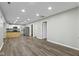 Open concept living space featuring wood floors, recessed lighting, and kitchen with stainless steel appliances at 802 N Tuxedo St, Indianapolis, IN 46201