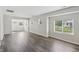 Spacious living room with wood-look flooring, neutral walls, and plenty of natural light from large windows at 802 N Tuxedo St, Indianapolis, IN 46201