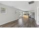 Bright and airy living space with wood-look flooring, neutral paint, and an open view of the kitchen at 802 N Tuxedo St, Indianapolis, IN 46201