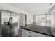 Open-concept living room area with hardwood floors and stainless steel refrigerator, and a view to the front door at 802 N Tuxedo St, Indianapolis, IN 46201