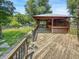 Backyard area with wooden deck, wooden bar, playset, and a grassy area at 812 Timber Creek Dr, Indianapolis, IN 46239