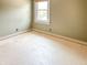 Bedroom featuring neutral colored walls, a window for natural light and bright floors ready for renovation at 812 Timber Creek Dr, Indianapolis, IN 46239