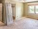 Bedroom featuring bright natural light, a ceiling fan and a closet space ready for renovation at 812 Timber Creek Dr, Indianapolis, IN 46239