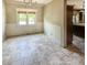 Cozy dining room with tile flooring, a classic chandelier, and natural light from the window at 812 Timber Creek Dr, Indianapolis, IN 46239