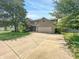 Traditional two-story home featuring brick accents, an attached garage, and a long driveway lined with mature trees at 812 Timber Creek Dr, Indianapolis, IN 46239