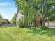 Well-maintained front yard with a large shade tree and charming two-story home with brick and vinyl siding at 812 Timber Creek Dr, Indianapolis, IN 46239