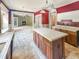 Bright kitchen featuring a center island with tile countertops and views into the living room and dining area at 812 Timber Creek Dr, Indianapolis, IN 46239