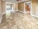 Open living room layout with tile flooring and natural light beaming through open doorways at 812 Timber Creek Dr, Indianapolis, IN 46239