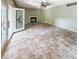 A spacious living room with tile flooring, fireplace and glass doors to the outside at 812 Timber Creek Dr, Indianapolis, IN 46239