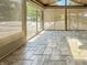 Enclosed sun room with tile floors, screens, and a view of the deck at 812 Timber Creek Dr, Indianapolis, IN 46239