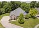 Aerial view of the house with a long driveway, manicured lawn, and lush trees at 815 Copperfield Ln, Danville, IN 46122