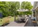Spacious back deck with outdoor furniture, umbrella, and wooded views at 815 Copperfield Ln, Danville, IN 46122