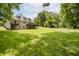 A brick home featuring a walkout basement and back deck overlooking the expansive lawn at 815 Copperfield Ln, Danville, IN 46122