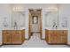 Bright bathroom featuring double vanity, marble countertops, and decorative mirrors at 815 Copperfield Ln, Danville, IN 46122