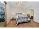 Bright bedroom with wood floors, a black metal bed, and a walk-in closet at 815 Copperfield Ln, Danville, IN 46122