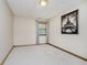 Bedroom with a window, carpeted floor, neutral paint and an Eiffel Tower picture on the wall at 815 Copperfield Ln, Danville, IN 46122