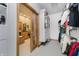 Walk-in closet with shelving and clothes racks, with an open door into a vanity area with wood cabinets and sink at 815 Copperfield Ln, Danville, IN 46122