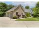 A beautiful home featuring brick accents, a three-car garage, and manicured landscaping at 815 Copperfield Ln, Danville, IN 46122