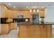 Stylish kitchen features granite countertops, wood cabinetry, stainless steel appliances, and a center island with pendant lighting at 815 Copperfield Ln, Danville, IN 46122