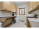 Functional laundry room with ample storage cabinets, folding counter, sink, and modern appliances at 815 Copperfield Ln, Danville, IN 46122