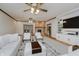 Open-concept living room featuring a cozy fireplace, plush white seating, and stylish decor at 815 Copperfield Ln, Danville, IN 46122