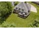 A beautiful rear exterior showcasing a large deck, lush lawn, and mature trees at 815 Copperfield Ln, Danville, IN 46122