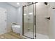 Modern bathroom featuring a glass shower with black trim and a soaking tub at 8355 Fieldfare Way, Indianapolis, IN 46237