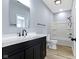 Bathroom featuring modern vanity, black fixtures, tile flooring, and tub and shower combo at 8355 Fieldfare Way, Indianapolis, IN 46237