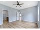 Bedroom featuring wood-look floors and access to an ensuite bathroom at 8355 Fieldfare Way, Indianapolis, IN 46237